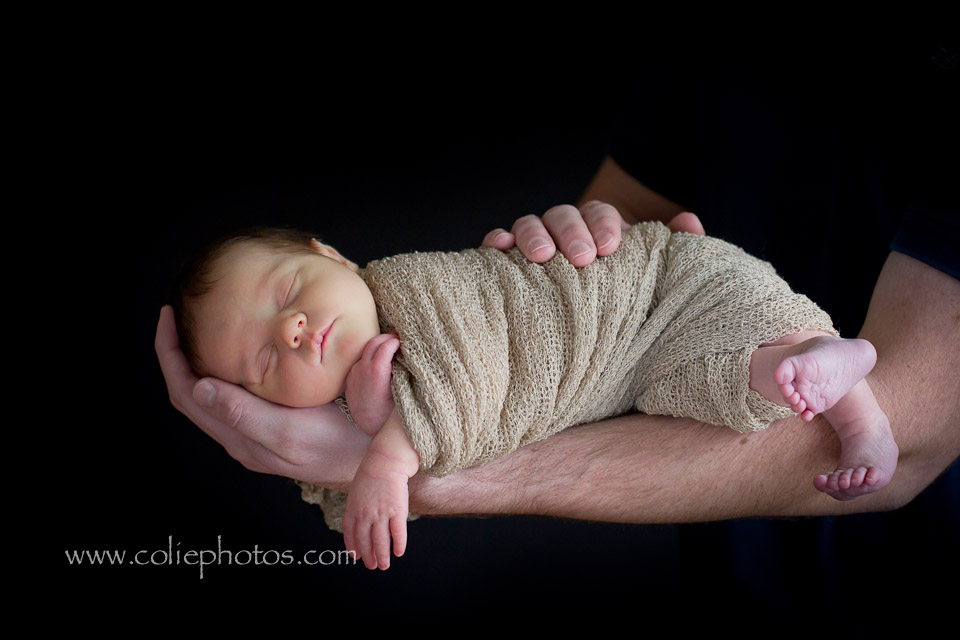 newborn on dad's arm