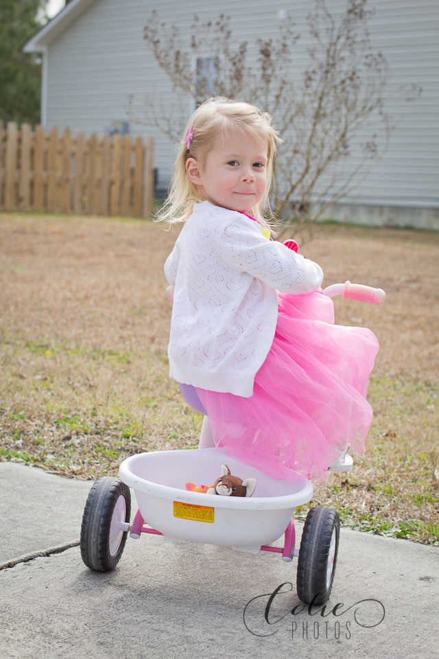 little girl on tricycle